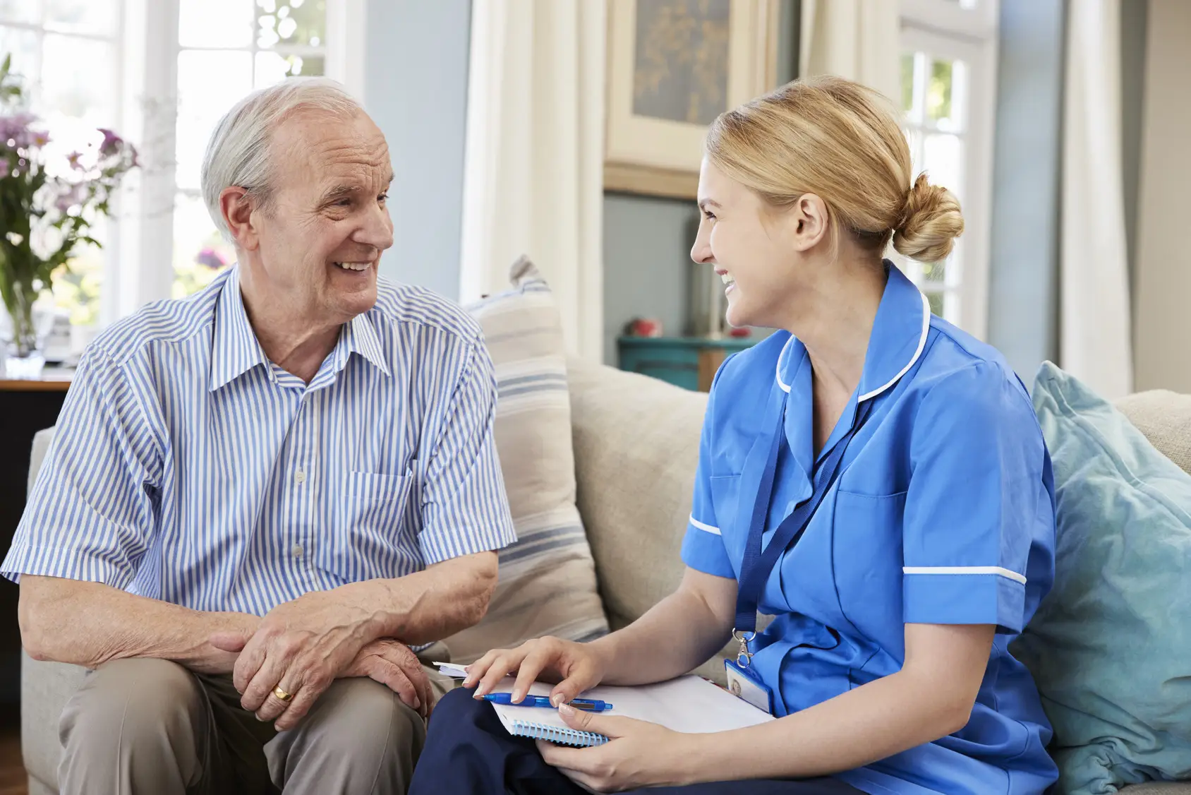 elderly senior being brought meal by carer or nurse